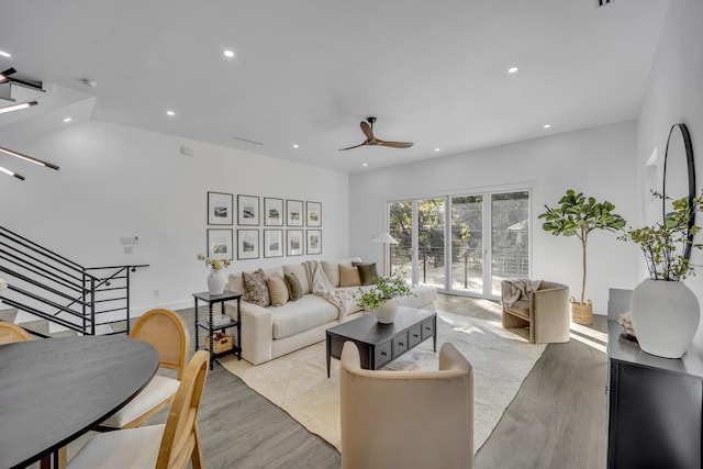 living room with ceiling fan and light wood-type flooring