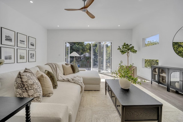 living room featuring ceiling fan and light hardwood / wood-style flooring