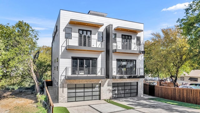 contemporary house featuring a balcony and a garage