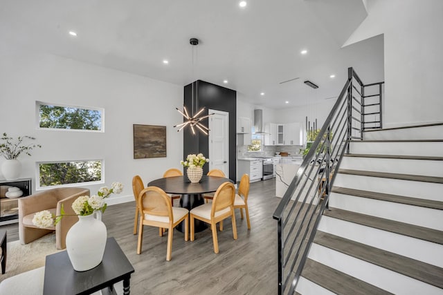 dining area featuring lofted ceiling and light hardwood / wood-style flooring