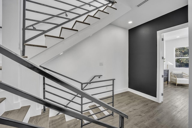 stairway with hardwood / wood-style flooring