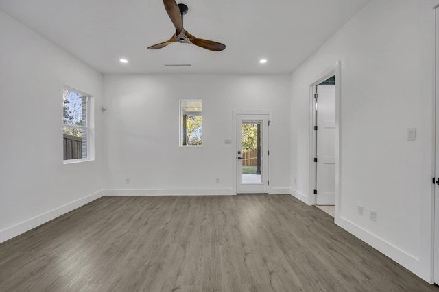 empty room with ceiling fan and hardwood / wood-style flooring