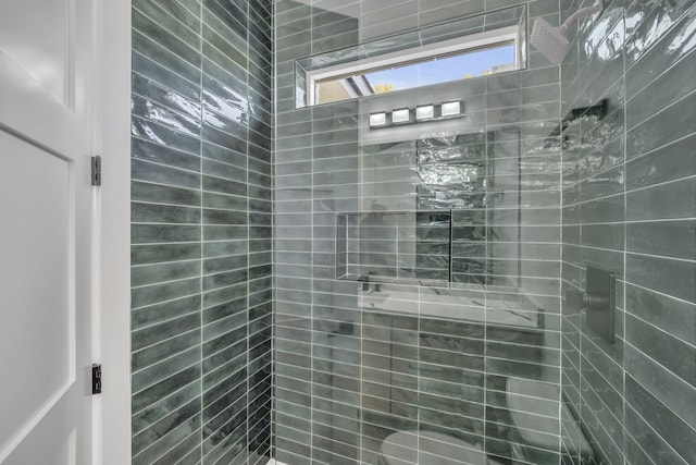 bathroom with a tile shower