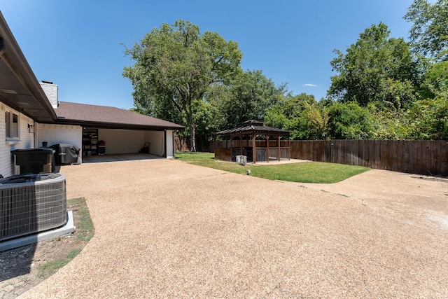 view of yard with a gazebo and central AC