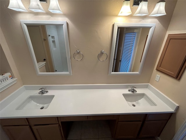 bathroom with tile patterned floors and vanity