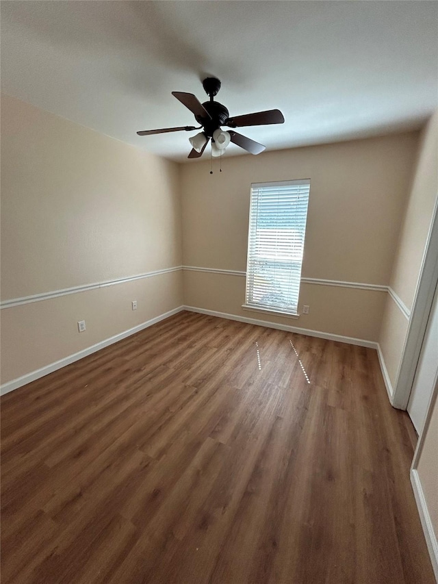 unfurnished room featuring dark hardwood / wood-style flooring and ceiling fan