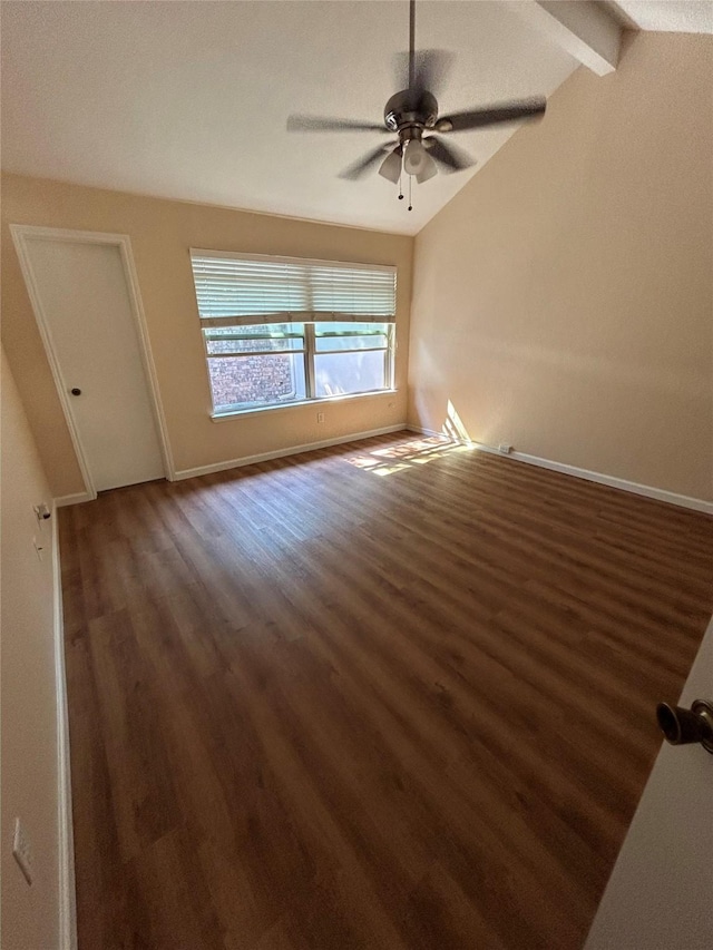 empty room with vaulted ceiling with beams, ceiling fan, and dark hardwood / wood-style floors