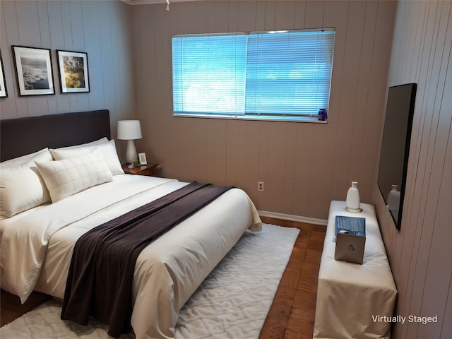 bedroom featuring wooden walls