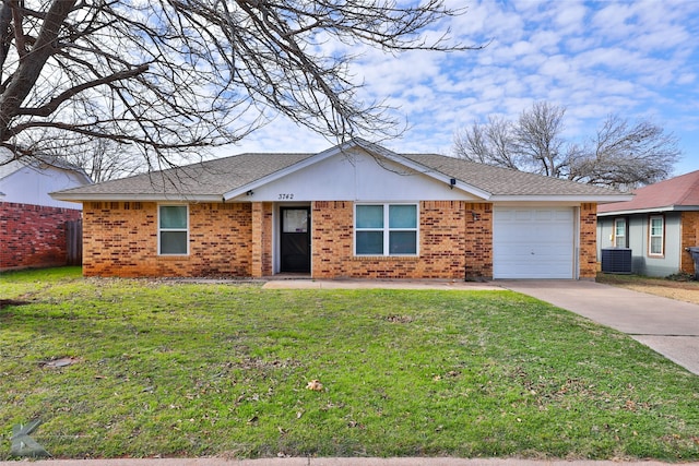 single story home with a front lawn, central AC unit, and a garage