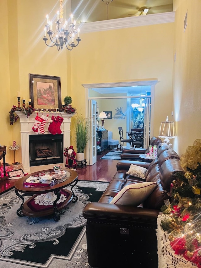 living room featuring wood-type flooring, an inviting chandelier, and ornamental molding