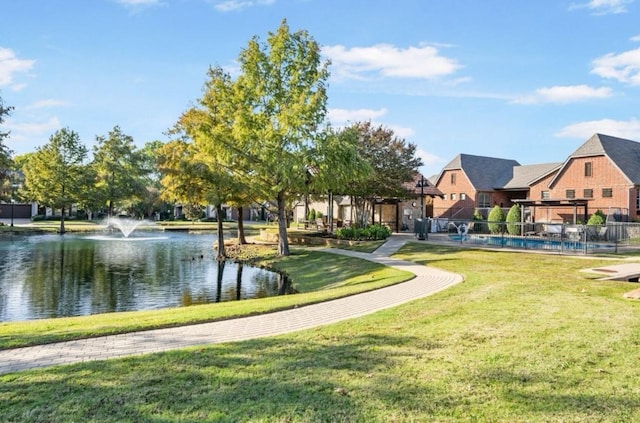 view of home's community featuring a water view and a yard