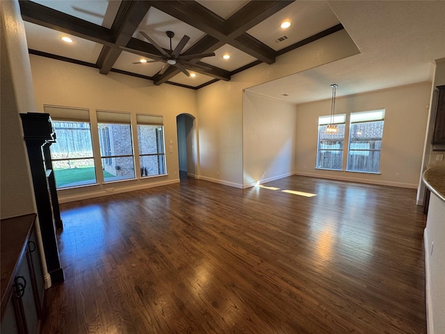 unfurnished living room featuring a wealth of natural light, beamed ceiling, dark wood-type flooring, and coffered ceiling