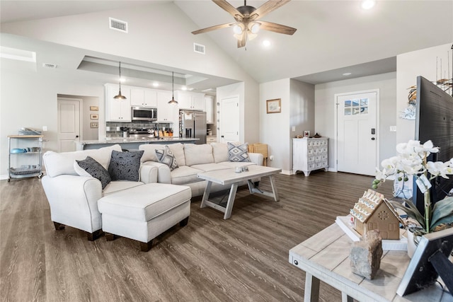 living room with lofted ceiling, ceiling fan, and dark hardwood / wood-style floors