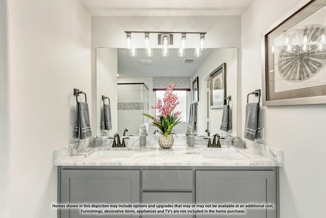 bathroom with vanity and a shower with shower door