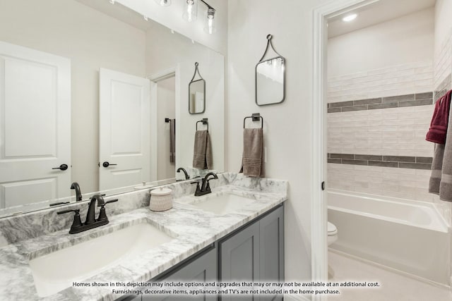 bathroom featuring a tub to relax in, vanity, and toilet