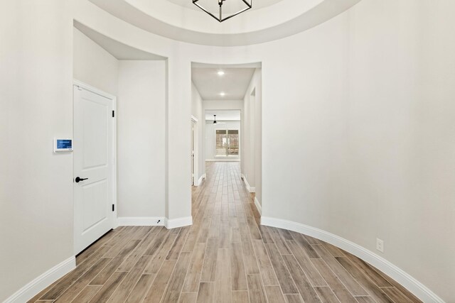 hallway with hardwood / wood-style flooring