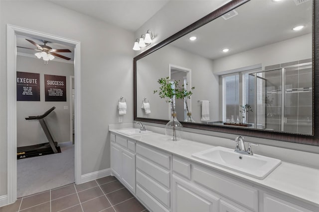 bathroom featuring tile patterned flooring, ceiling fan, a shower with door, and vanity