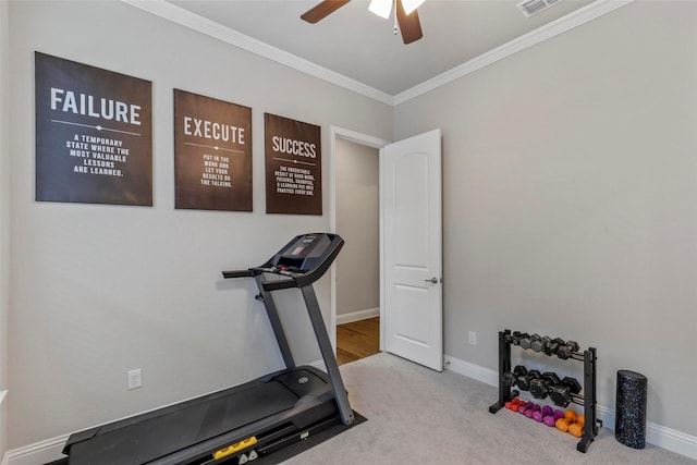 exercise room with light carpet, ceiling fan, and crown molding