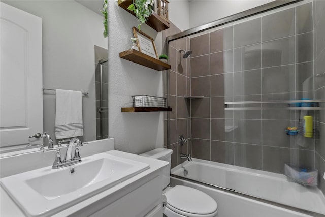 full bathroom featuring shower / bath combination with glass door, vanity, and toilet