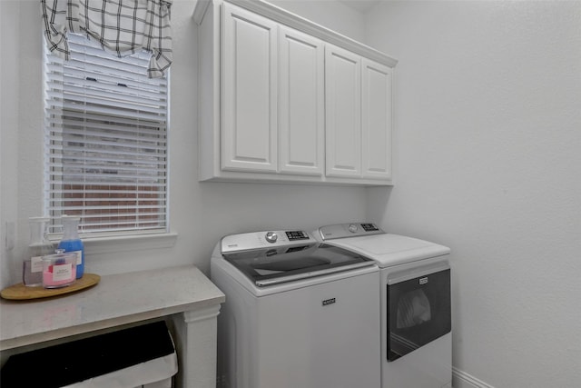 laundry area with cabinets and washing machine and clothes dryer