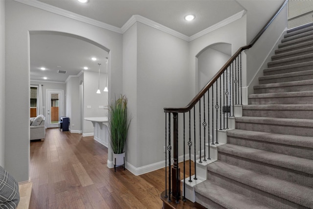 foyer with hardwood / wood-style flooring and ornamental molding