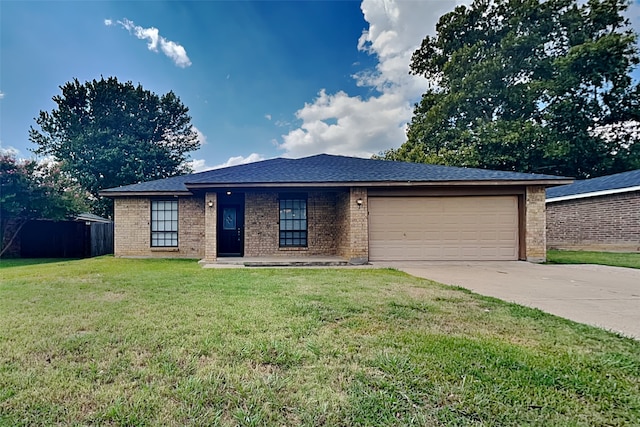 view of front of property with a garage and a front lawn