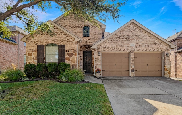 front of property with a front yard and a garage