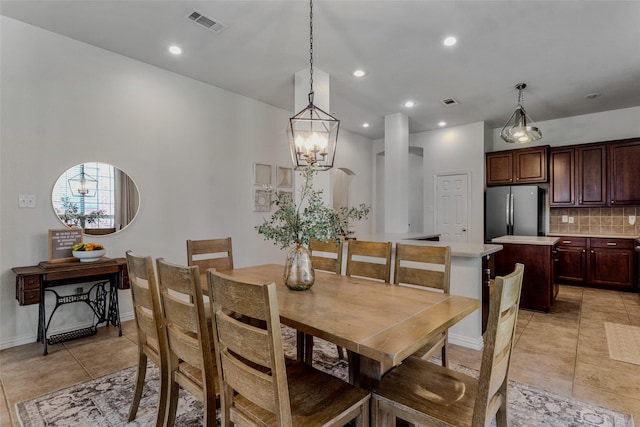 dining room featuring light tile patterned flooring and a chandelier