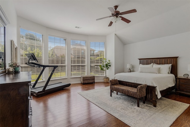 bedroom with multiple windows, ceiling fan, dark hardwood / wood-style flooring, and lofted ceiling