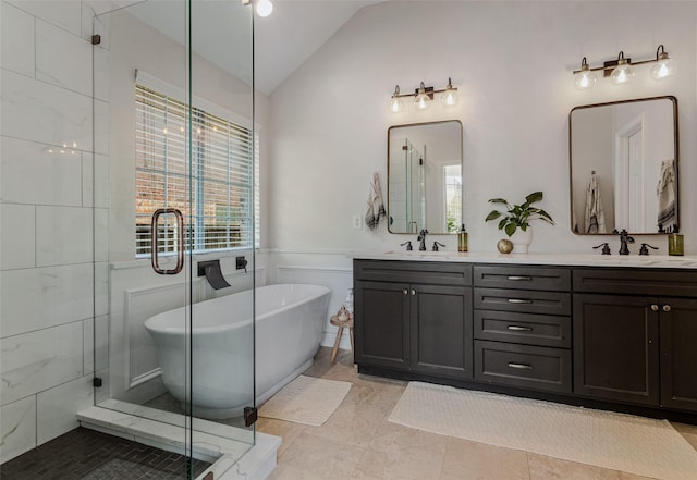 bathroom with tile patterned flooring, vanity, shower with separate bathtub, and vaulted ceiling