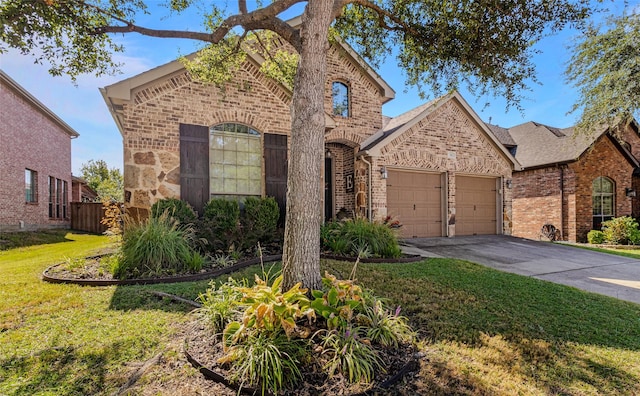 view of front of house with a front yard and a garage