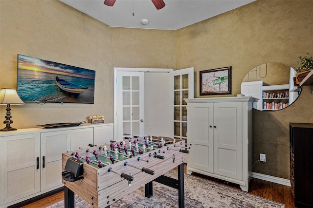 recreation room with ceiling fan, french doors, and hardwood / wood-style flooring