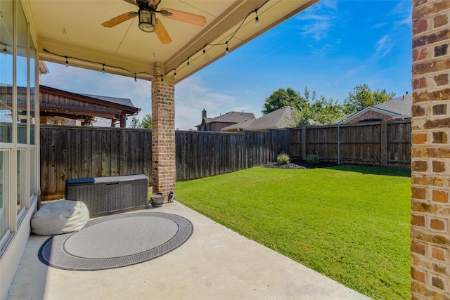 view of yard with ceiling fan and a patio