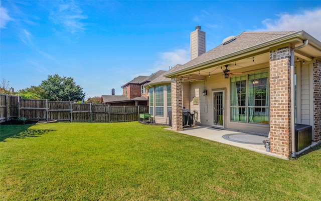 view of yard featuring a patio area and ceiling fan