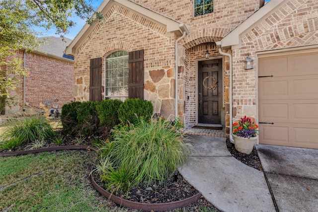 view of exterior entry with a garage