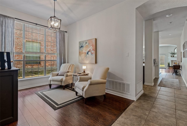 sitting room with tile patterned floors and a chandelier