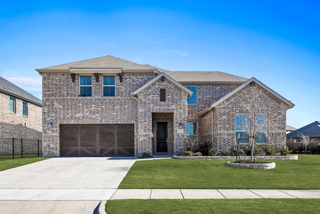 view of front property with a garage and a front lawn