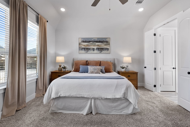 bedroom with ceiling fan, light colored carpet, and vaulted ceiling