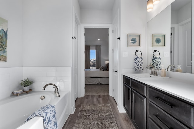 bathroom featuring a bathtub, wood-type flooring, and vanity