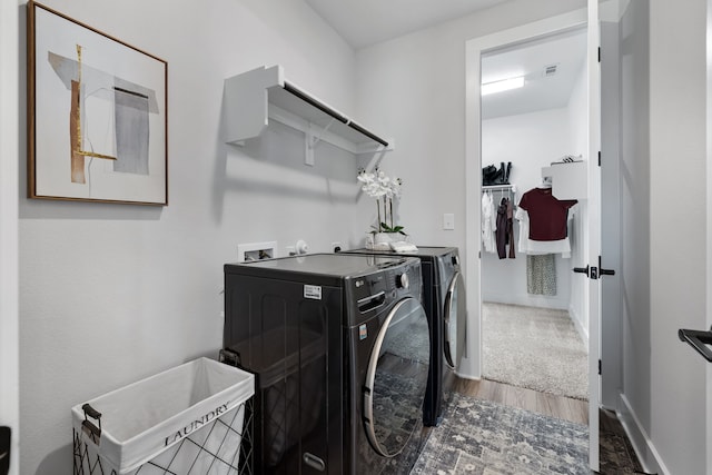 laundry area featuring separate washer and dryer and dark hardwood / wood-style floors