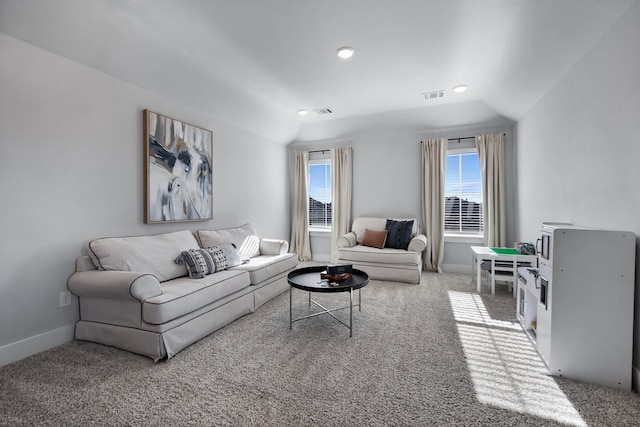 living room featuring carpet flooring and vaulted ceiling