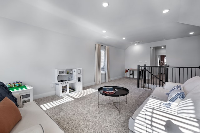 carpeted living room featuring vaulted ceiling