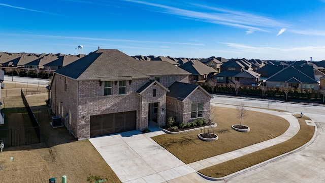 view of front of home with cooling unit, a garage, and a front yard