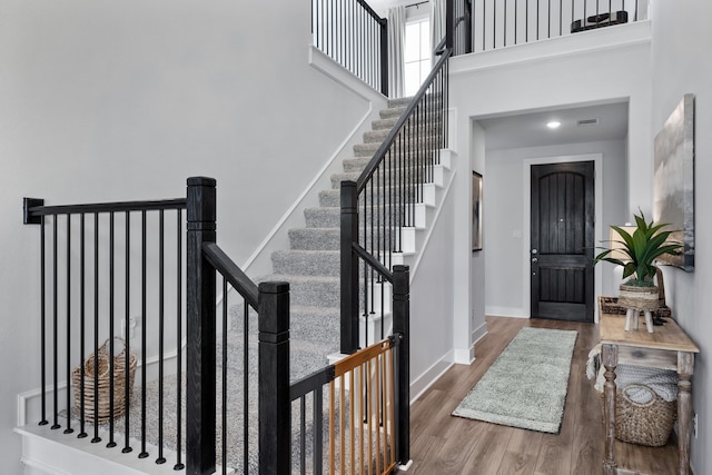 entryway with a high ceiling and hardwood / wood-style flooring