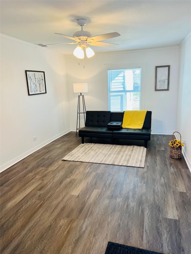 living room featuring ceiling fan, dark wood-type flooring, and ornamental molding