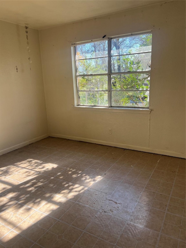 spare room with a healthy amount of sunlight