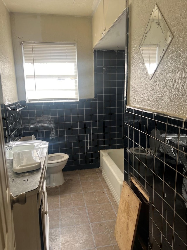 full bathroom with shower / bath combination, vanity, tile walls, tile patterned flooring, and toilet