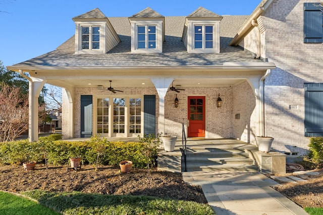 entrance to property with ceiling fan and a porch