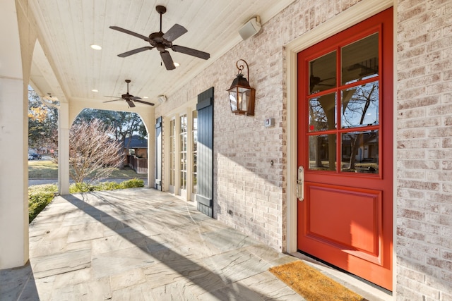 property entrance featuring ceiling fan and a porch