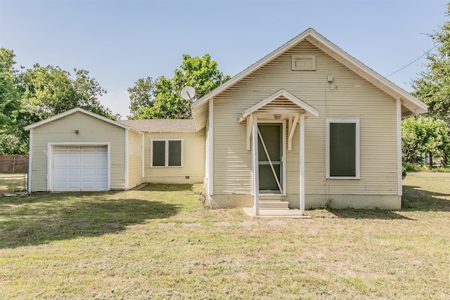 view of front of home with a front yard and a garage